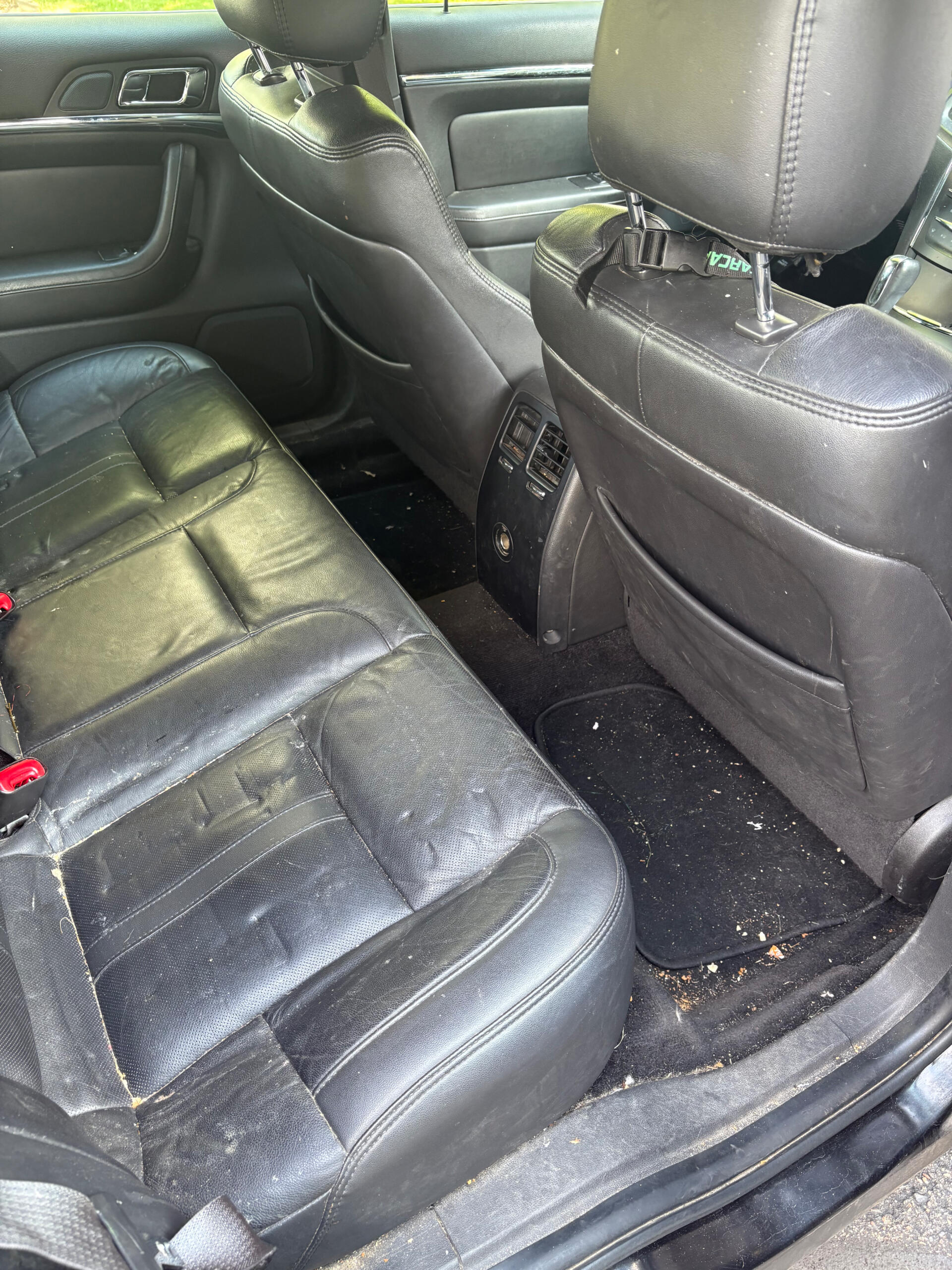 Four Seasons Detail before image of the dirty backseat of a car