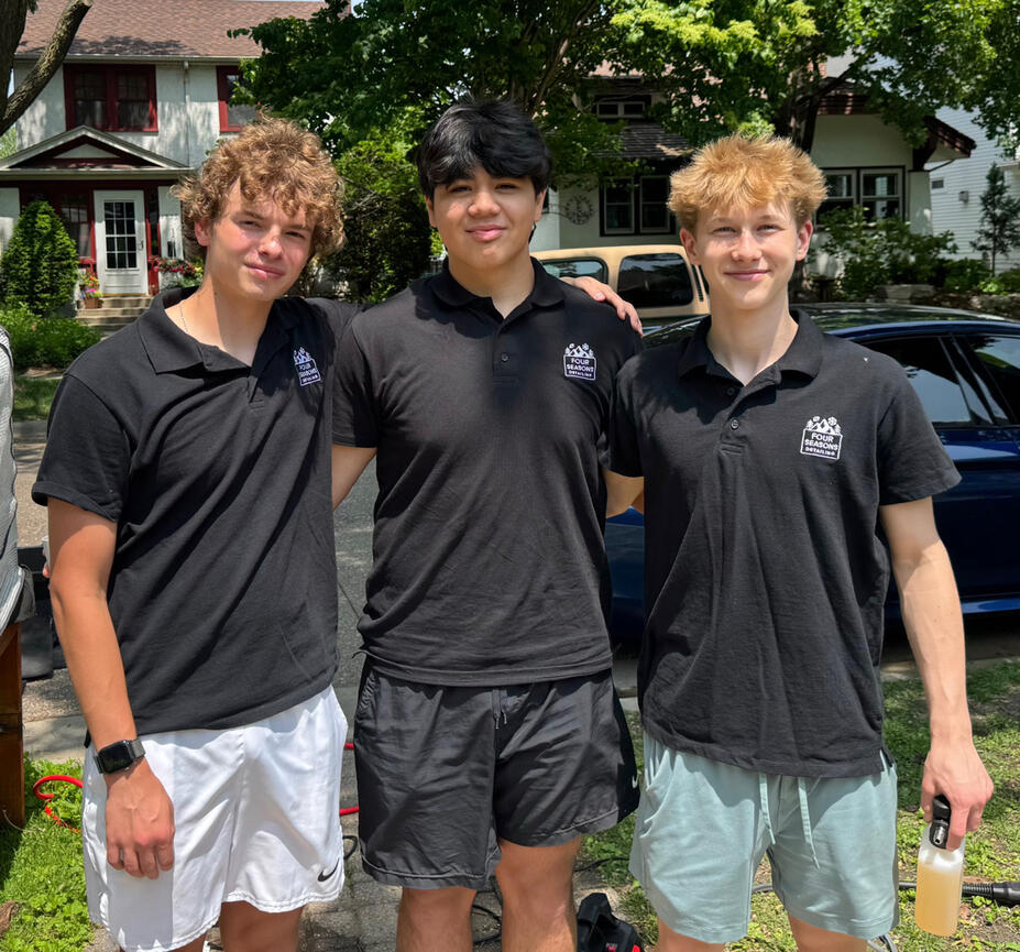 Four Seasons Detailing founders — Elliot, Will, and Ben Four Seasons Detailing team with branded shirts and detailing equipment in front of a clean car in the Twin Cities